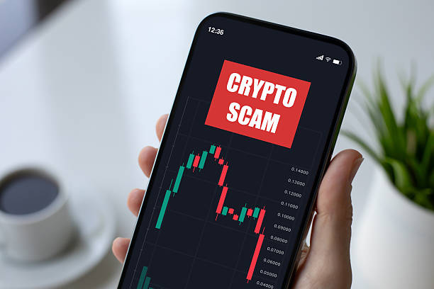 woman hand hold phone with chart of scam crypto coins on screen